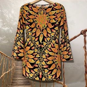 Multi colored mini dress with open back and shoulder pads